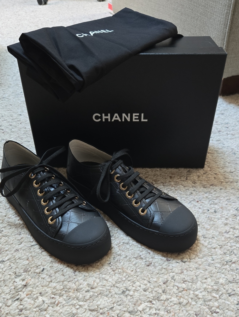 CHANEL Black Quilted Leather Low-Top Sneakers with Gold Eyelets